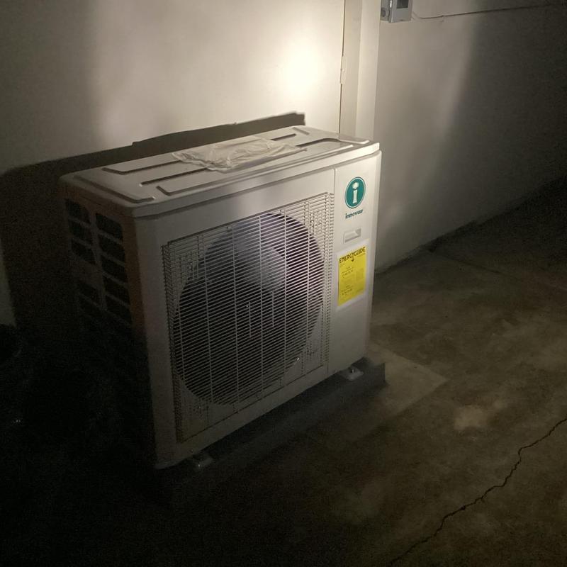 InnovaAir outdoor condenser unit installation in dimly lit area