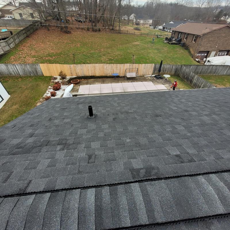 Asphalt shingle roof with vent pipe on suburban home
