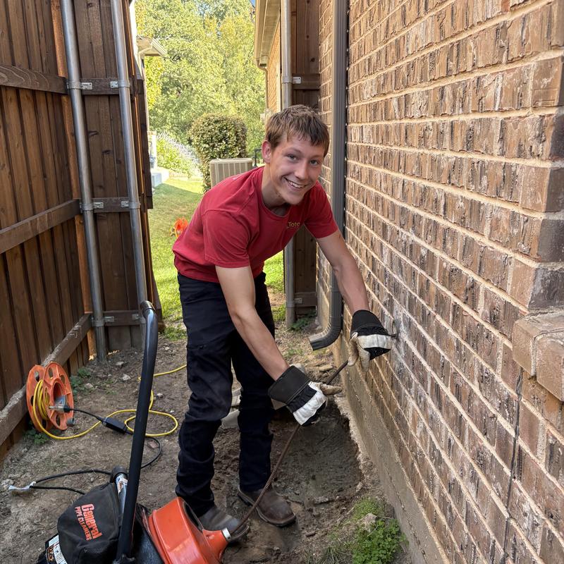 Kitchen sink drain clearing with plumber using auger tool
