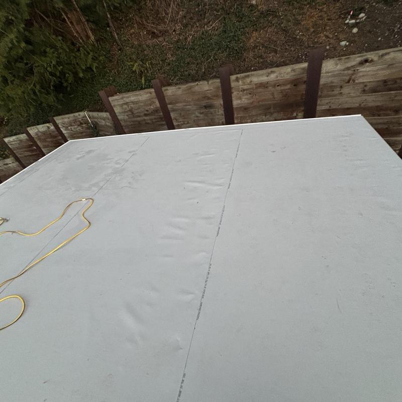Flat roof membrane installation with power cord nearby