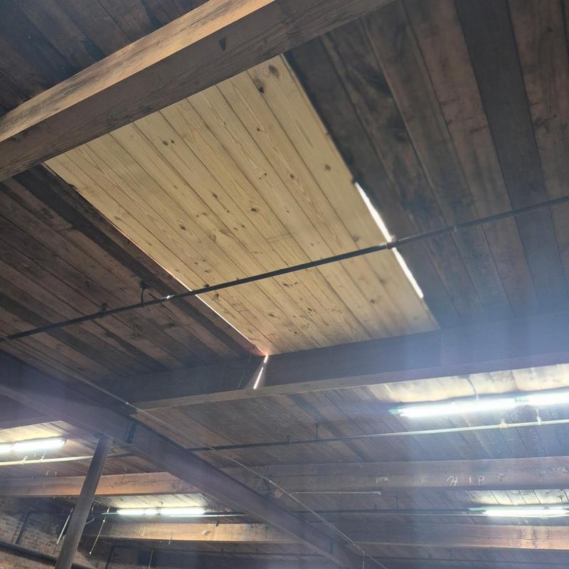 Wood deck replacement with new planks in ceiling beams