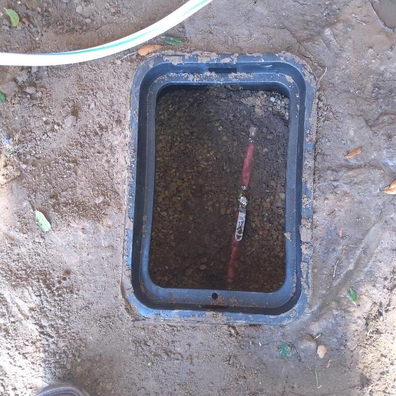 Yard water shutoff valve in ground box exposed