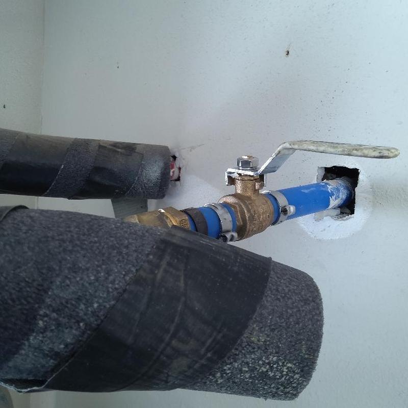 Hot water heater valve with blue piping and insulation