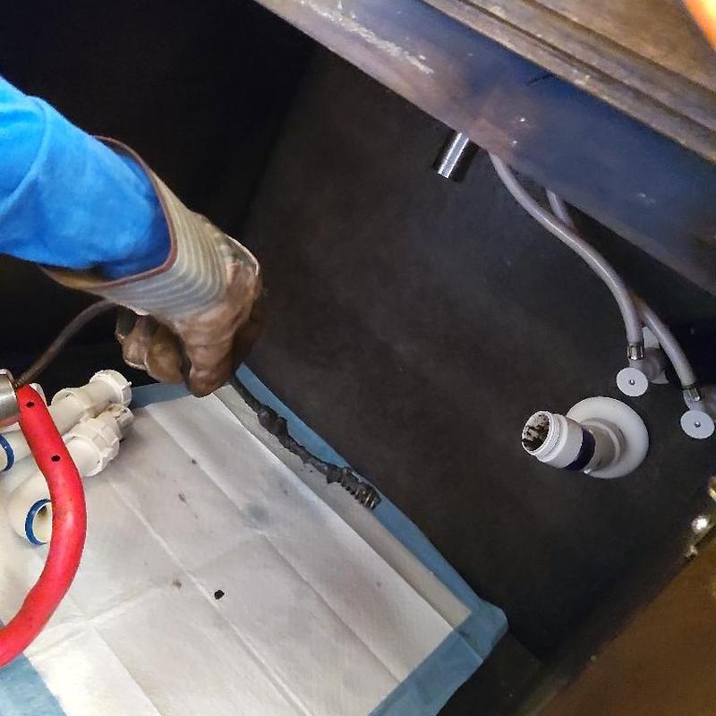 Bathroom sink drain pipe with clog removal tools