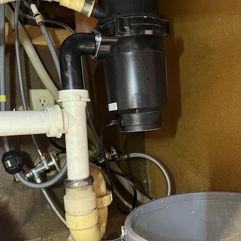 Badger garbage disposal under kitchen sink with pipes