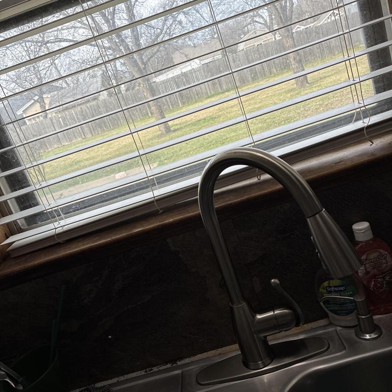 Kitchen faucet with stainless steel sink and window blinds