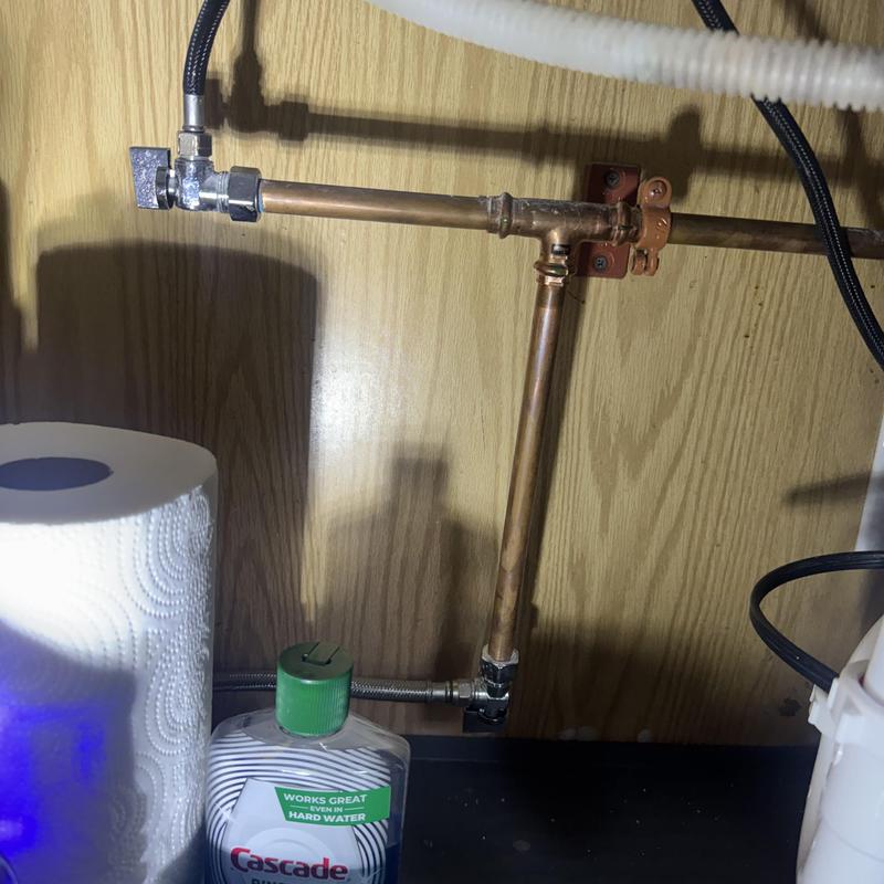 Copper water supply line under kitchen sink with valve