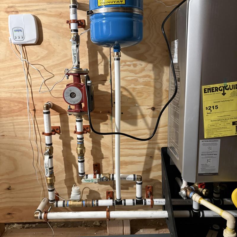 Tankless water heater with recirculating pump installation
