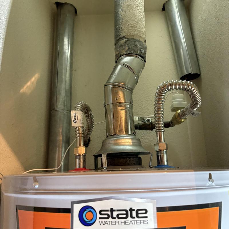 50-gallon gas water heater ventilation pipes in garage