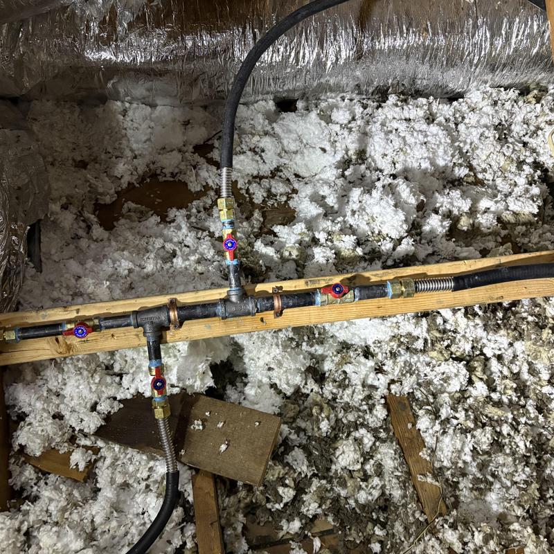 Gas piping with valves installed on attic wood beam