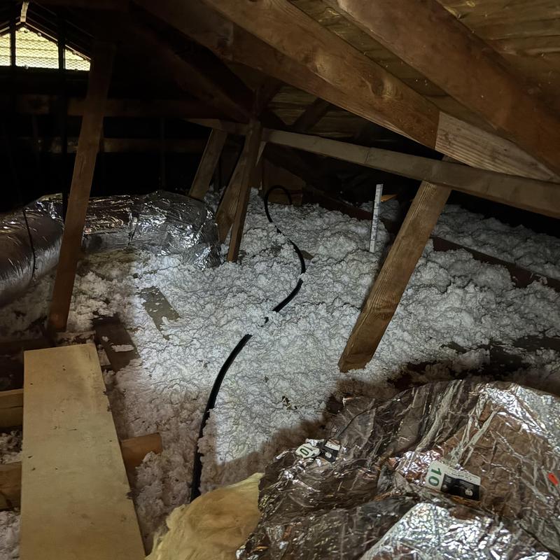 Gas piping run through attic insulation in house attic