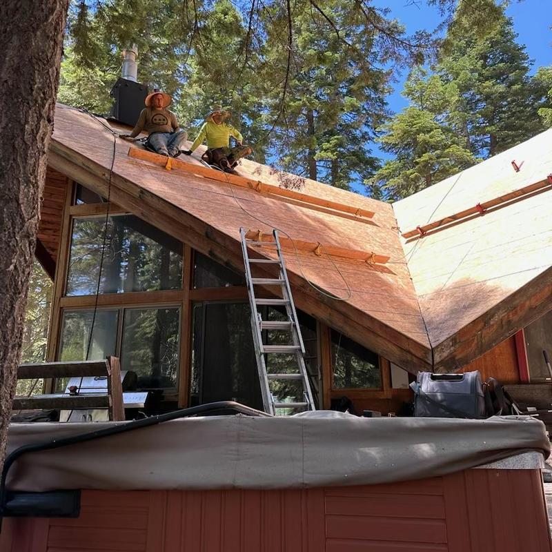 Half inch OSB roof decking installation on cabin roof