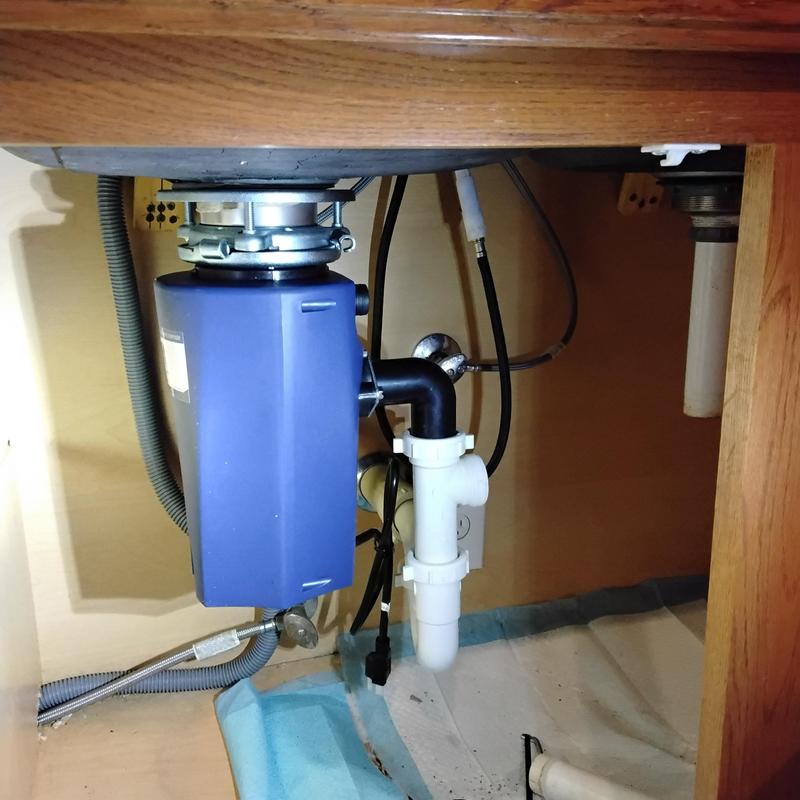 Garbage disposal and plumbing under kitchen sink installation