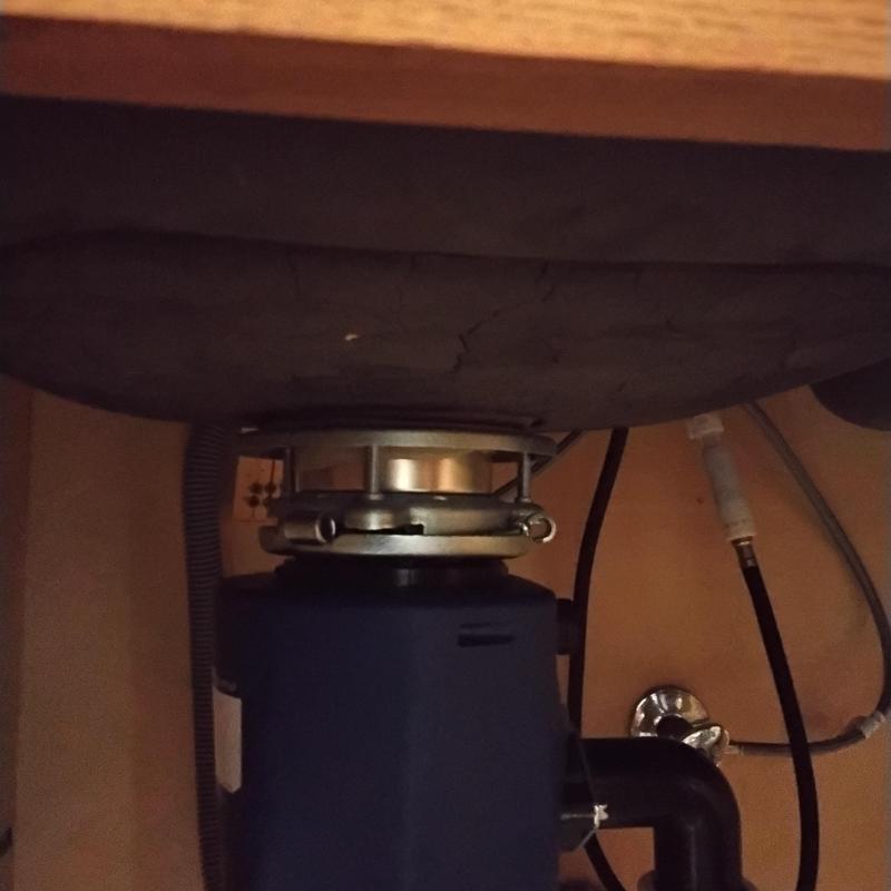 Garbage disposal unit installed under kitchen sink