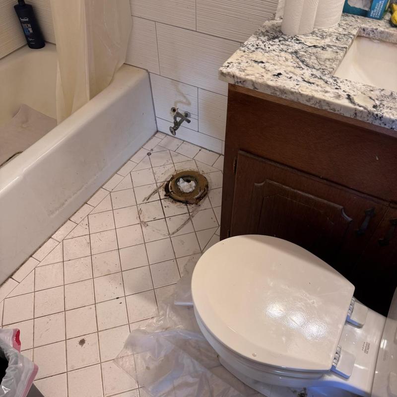 Toilet flange and bathroom floor tile repair area Toilet flange and bathroom floor tile repair area