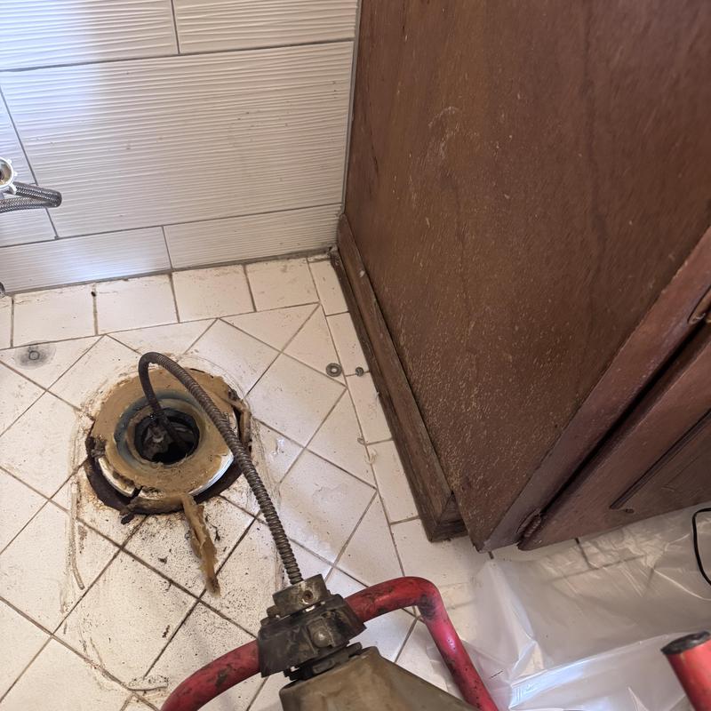 Cast iron mainline drain with plumbing snake tool Cast iron mainline drain with plumbing snake tool