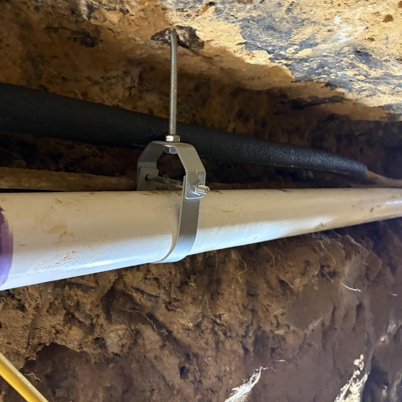 Drain repipe PVC pipe support in tunnel access