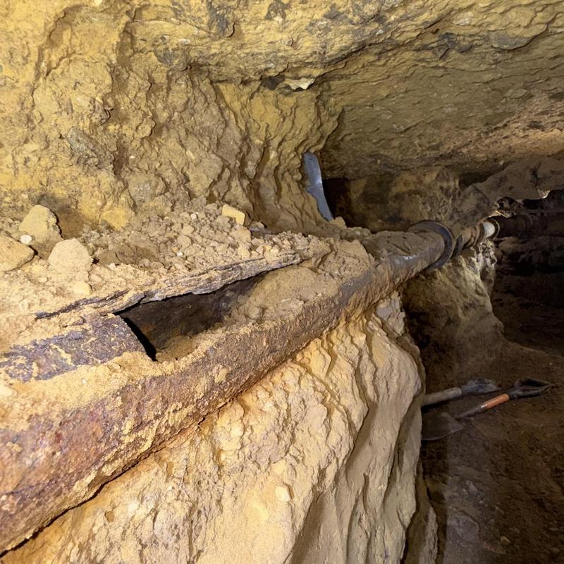 Drain pipe access tunnel with corroded pipe section