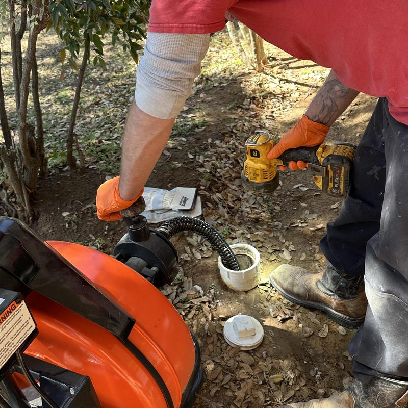Main drain cleaning with auger and power drill