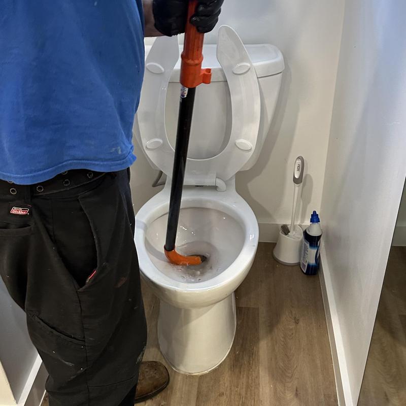 Toilet drain unclogging with plumbing auger tool