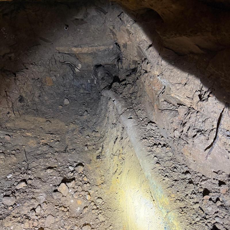 Collapsed 4-inch main sewer line under garage excavation