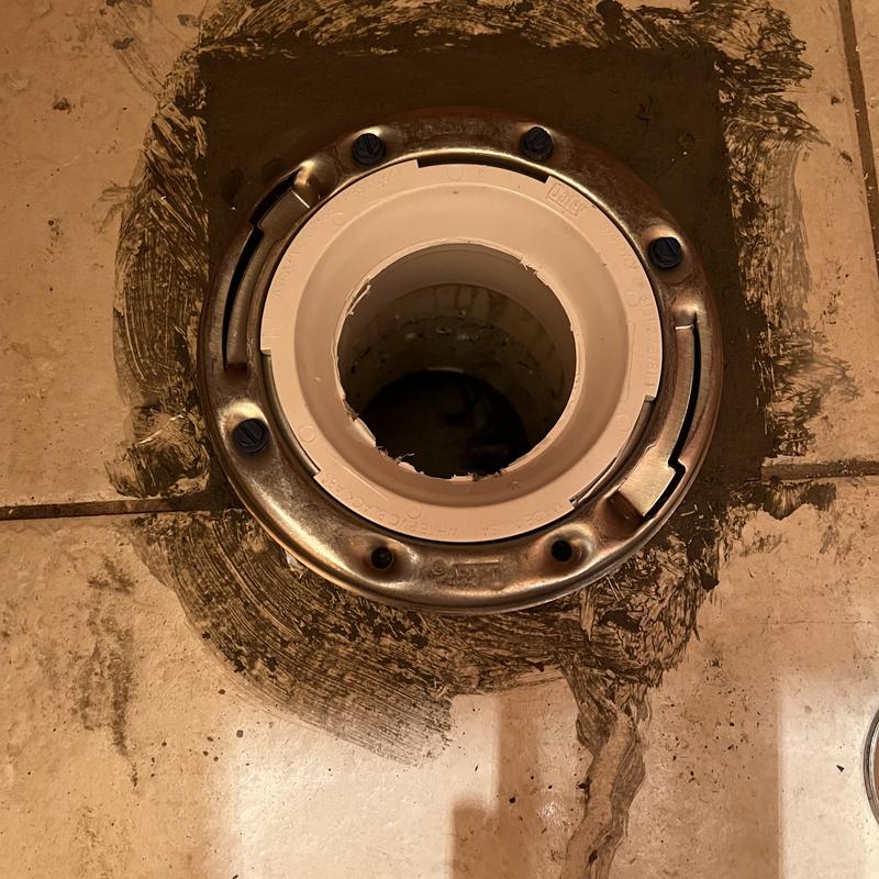 Toilet flange and sewer pipe installation in tiled floor