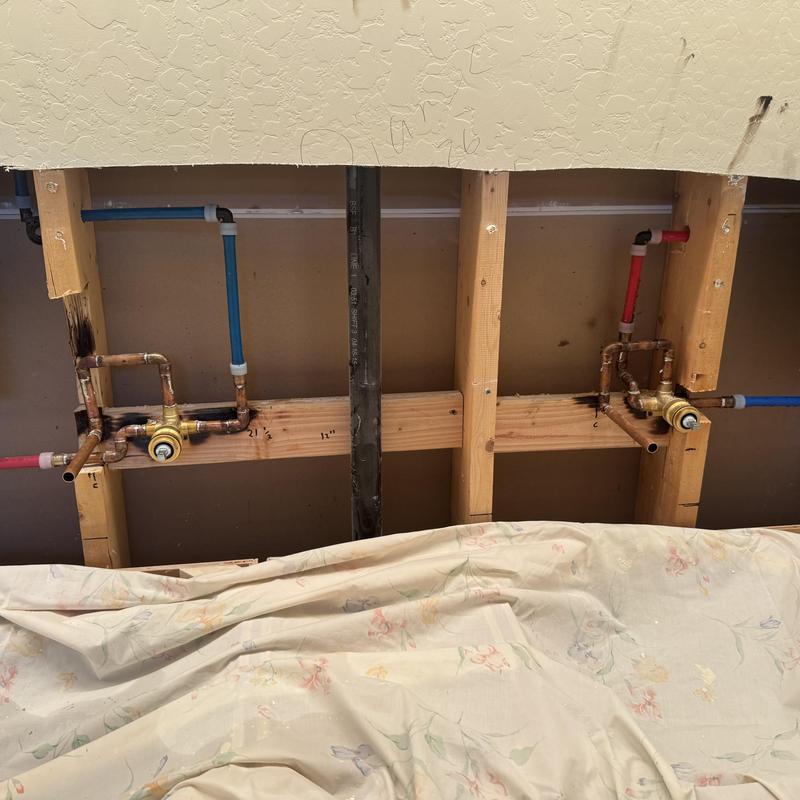 Wall-mounted faucet plumbing rough-in in bathroom wall