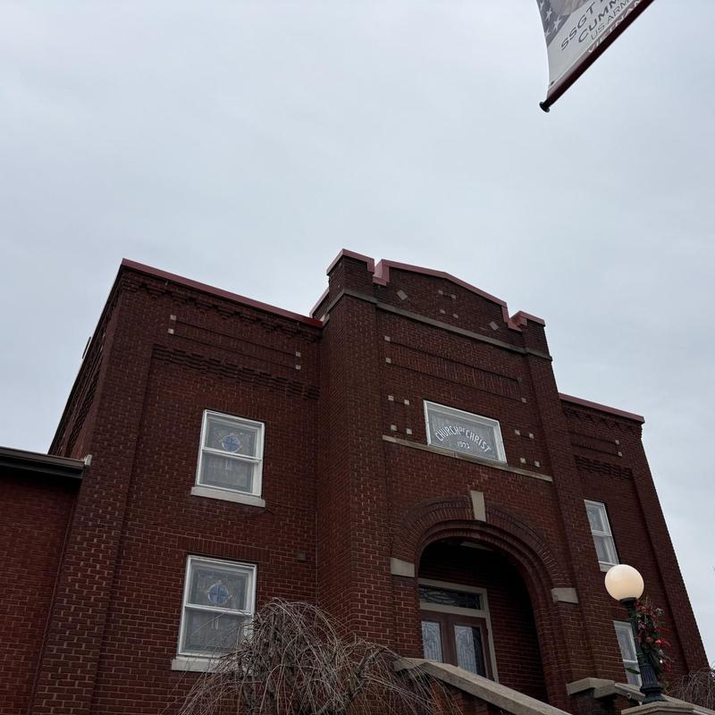 Brick exterior with architectural details and flagpole