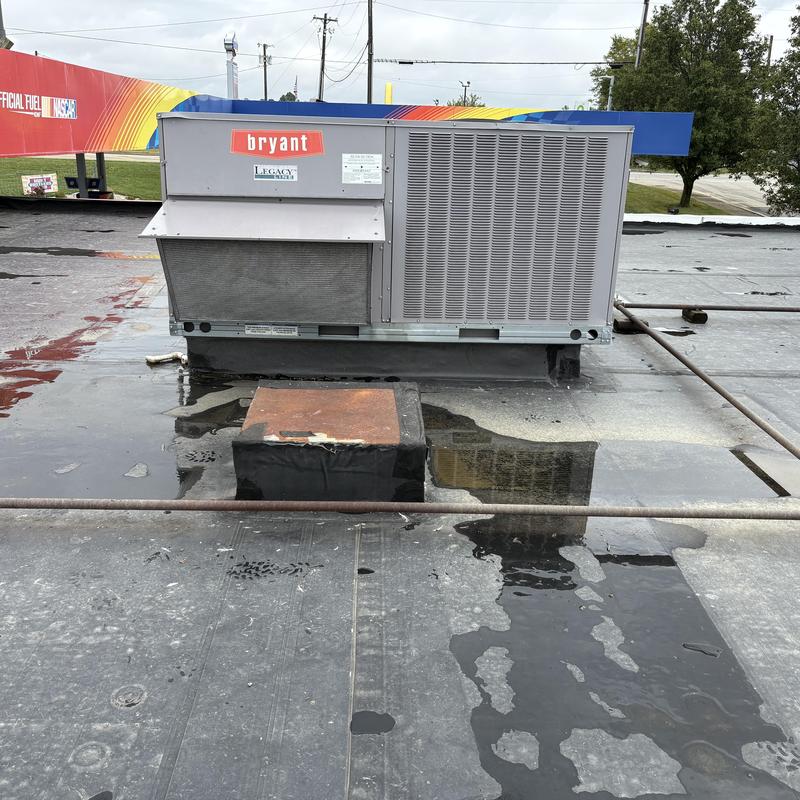 Rooftop Bryant HVAC unit with ponded water on roof