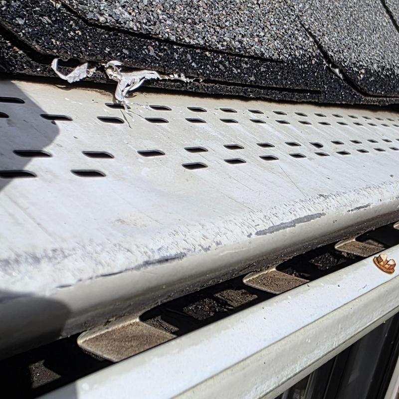 Metal gutter and shingle edge with hail damage in Terrell TX