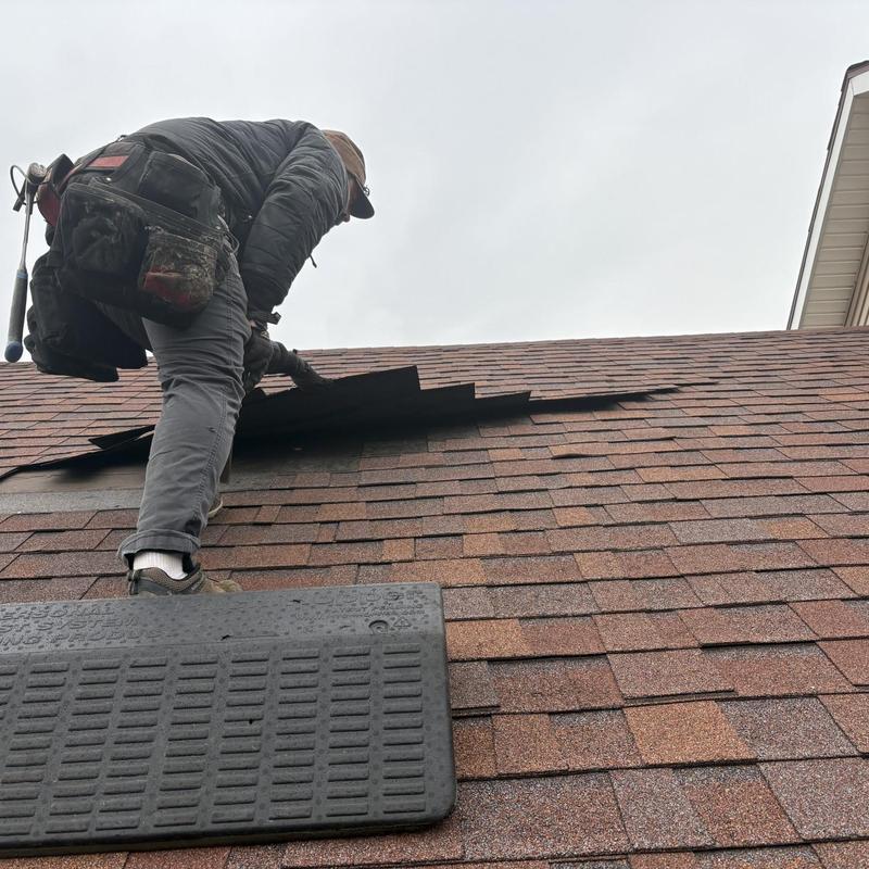 Roof shingles inspection with missing shingles on roof