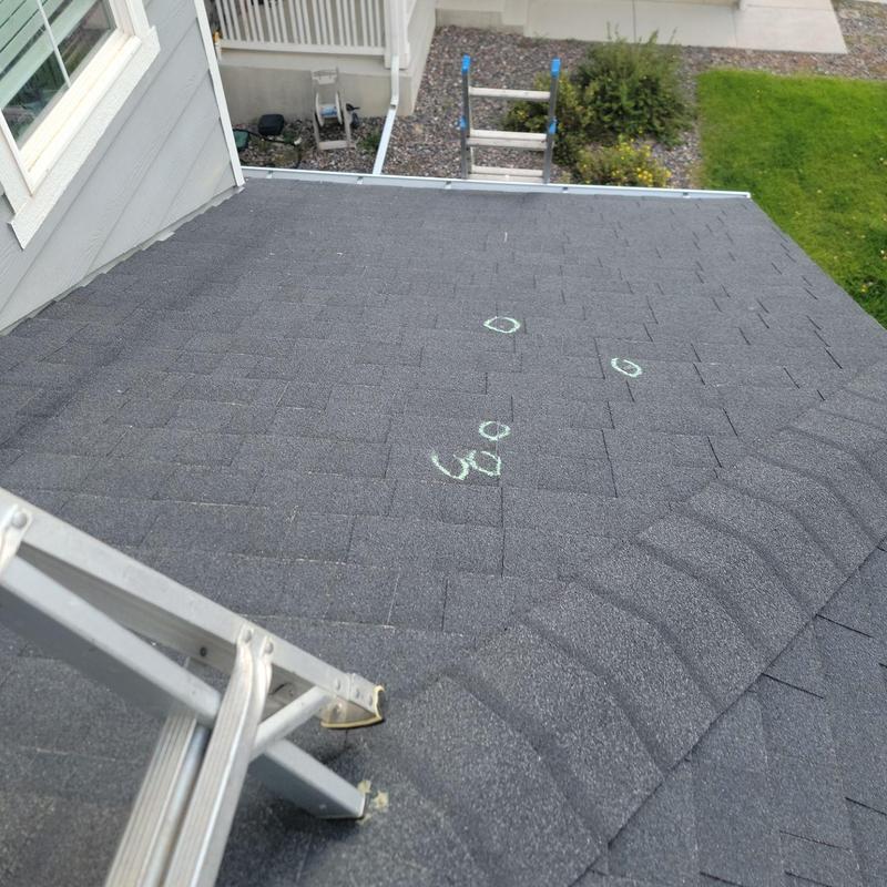 Roof shingles with marked hail damage spots Roof shingles with marked hail damage spots