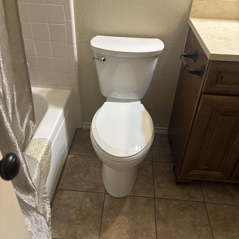 American Standard toilet installed in bathroom corner