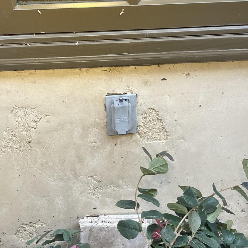 Exterior GFCI outlet with weatherproof cover on wall