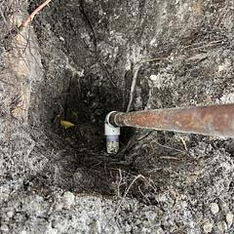 Backflow pipe with elbow joint dug up in soil
