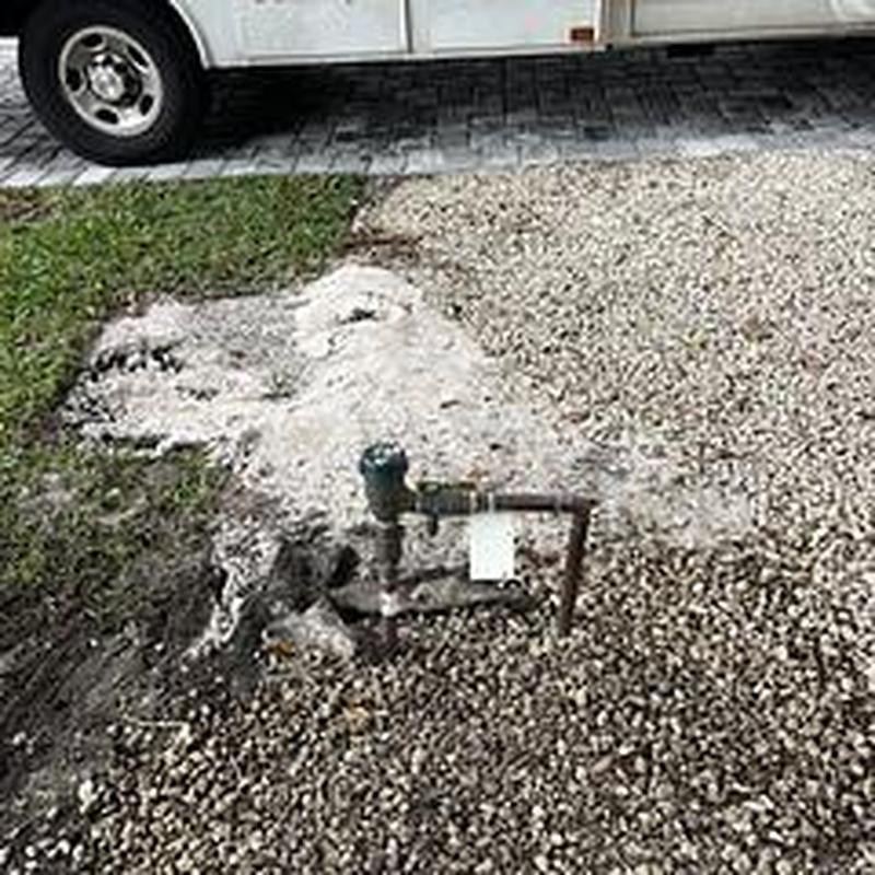 Backflow pipe excavation and repair with gravel covering