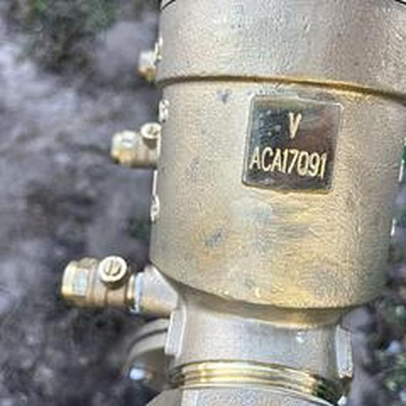Backflow preventer valve close-up with serial number plaque