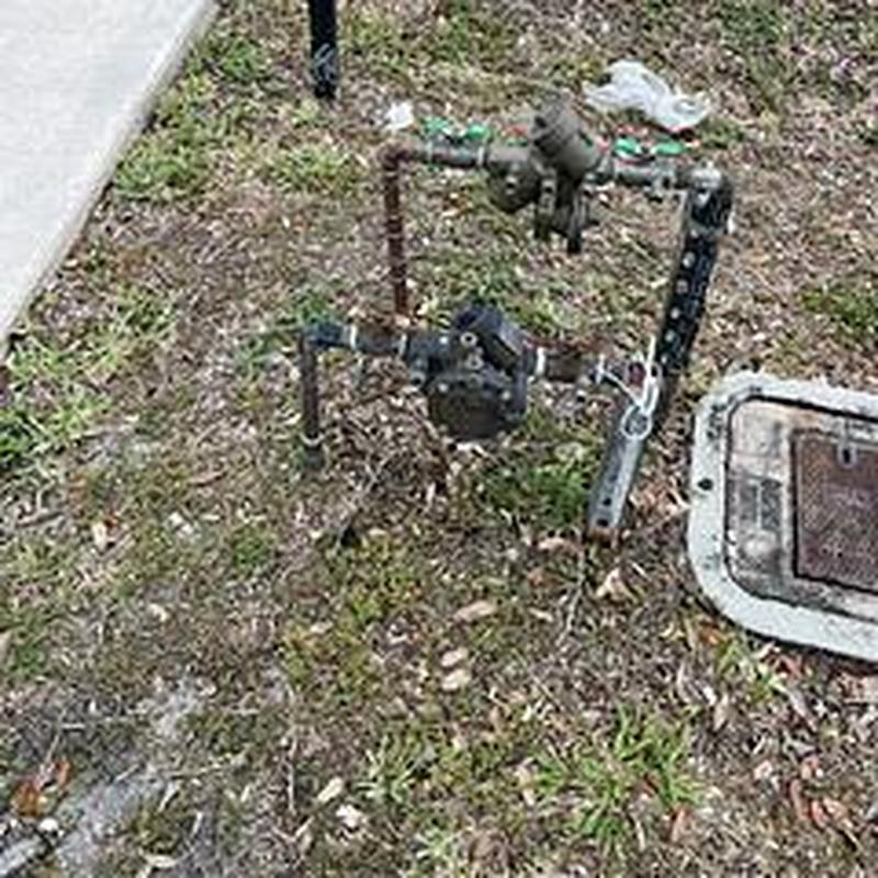 Backflow prevention device with piping outdoors