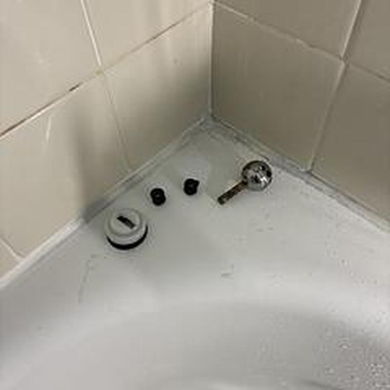 Delta shower valve repair kit parts on tub edge