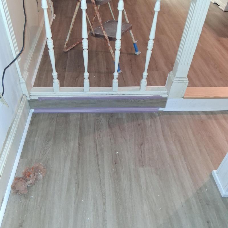 Wood landing tread installation with trim and moulding