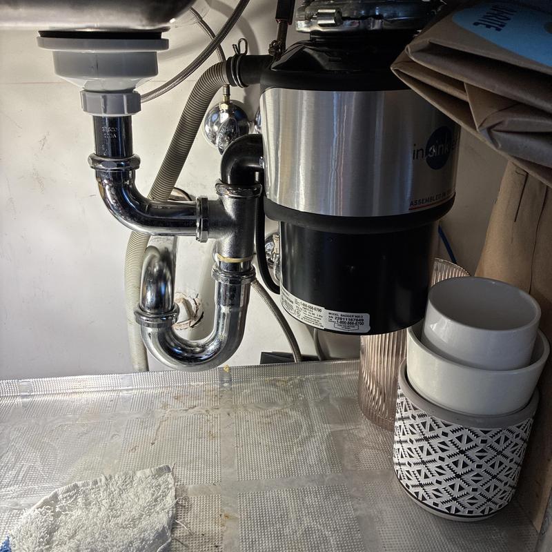 Kitchen sink trap and garbage disposal piping under sink