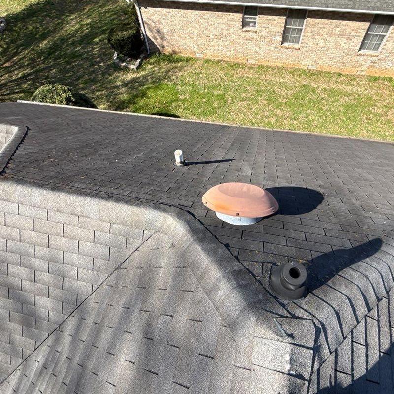 Roof shingles with vent pipes and ridge caps inspection