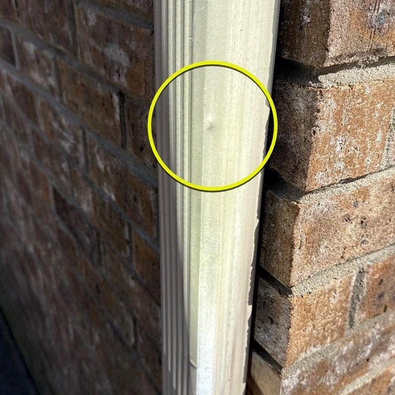 Downspout dent damage on metal gutter system