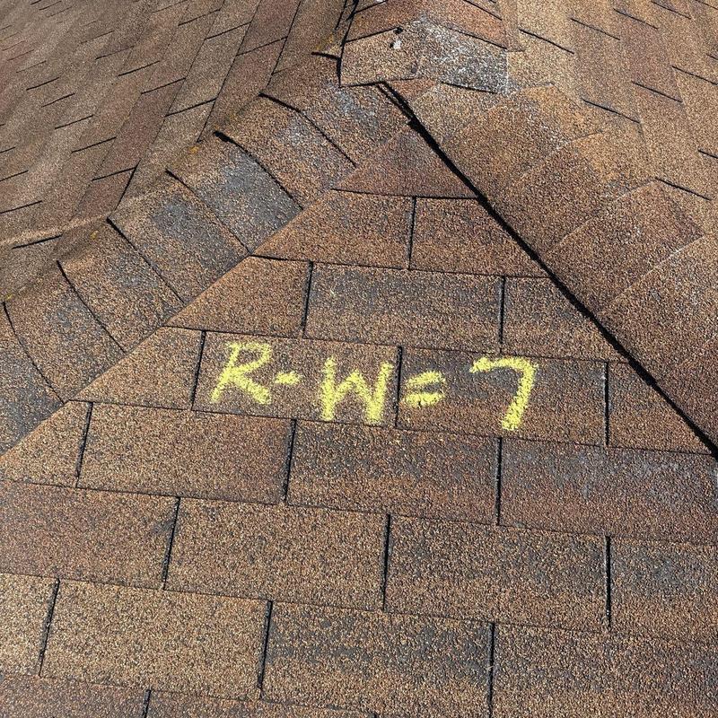 Roof shingles with chalk markings on ridge section