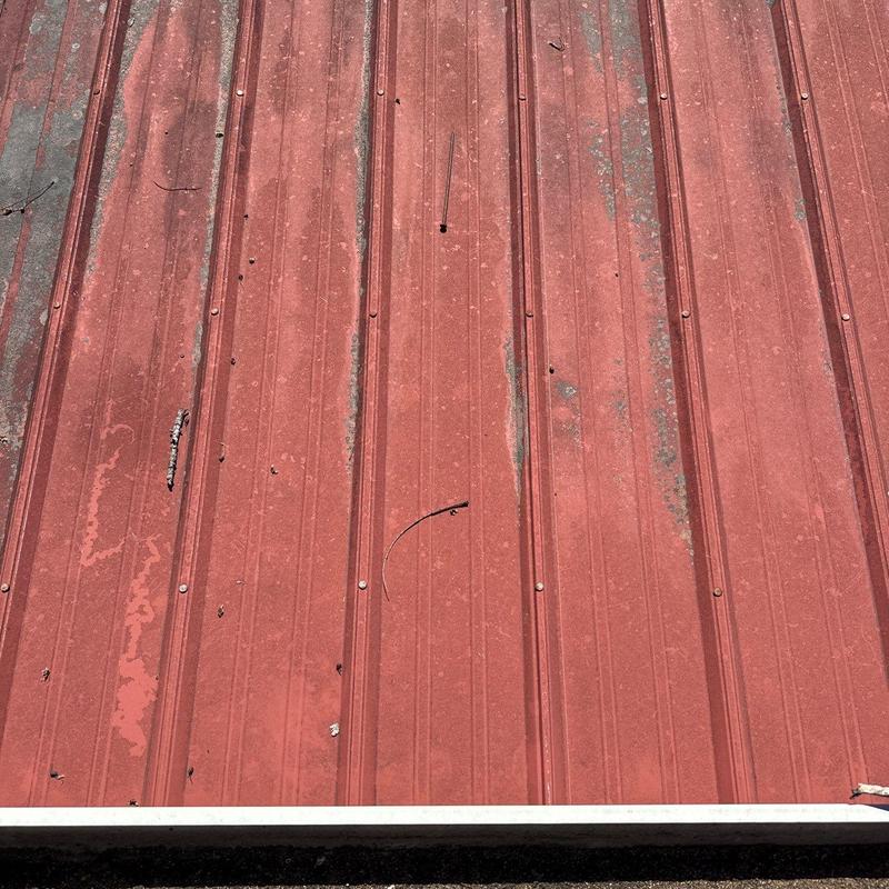 Metal roof panels with hail and rust damage