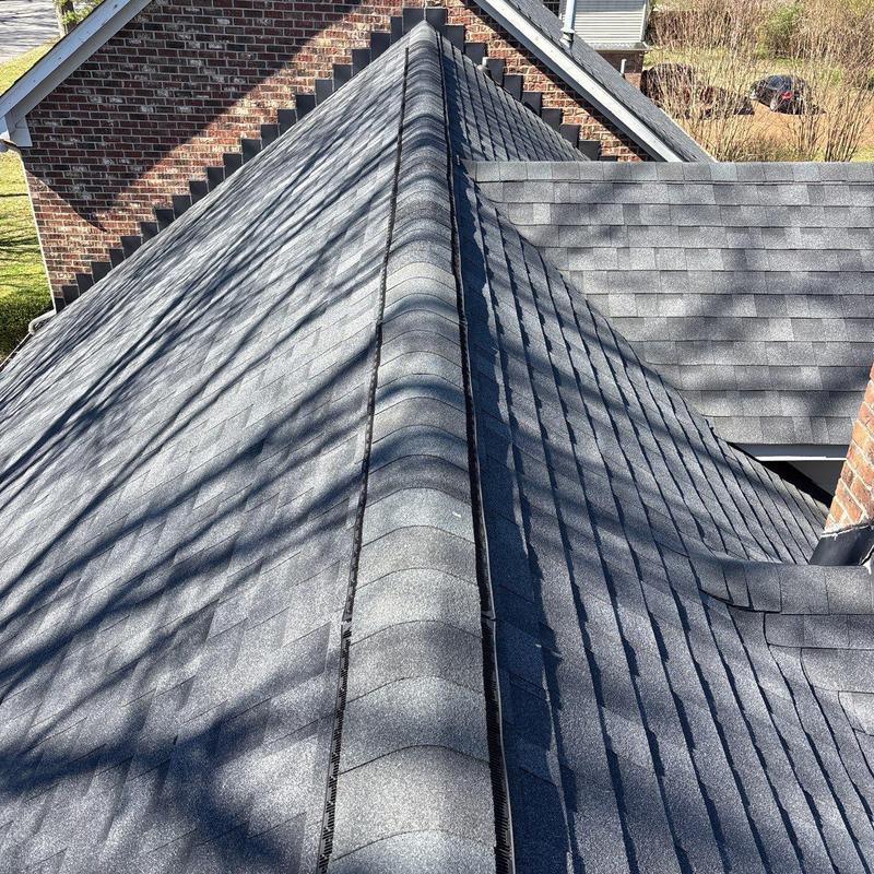 Asphalt shingle roof ridge with drill marks