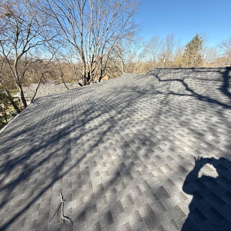 Asphalt shingle roof with hail damage and shadow