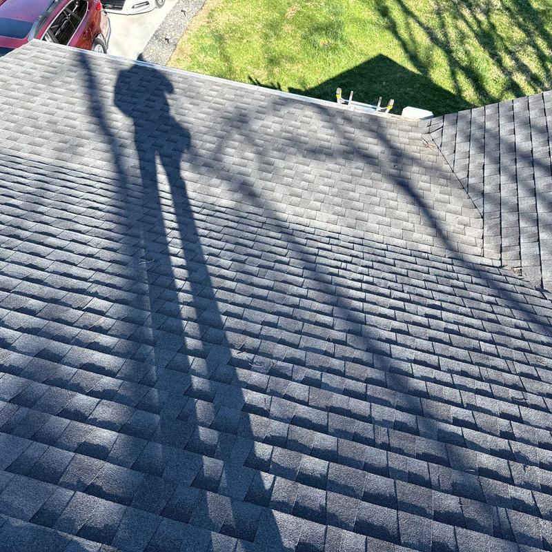Asphalt shingle roof with shadow and nearby lawn