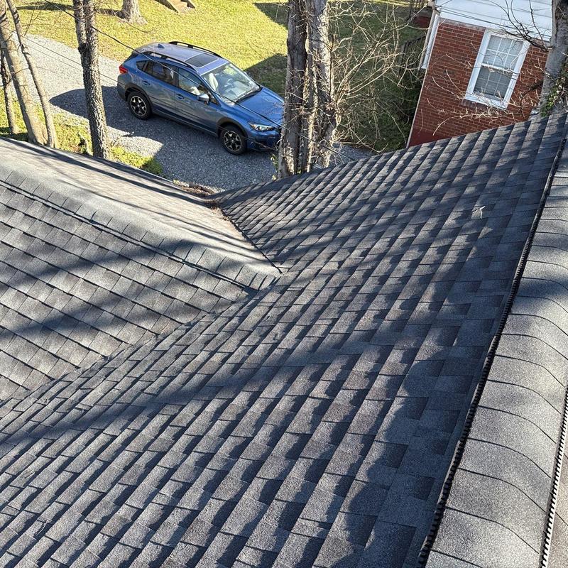 Asphalt shingle roof with visible hail damage and transitions