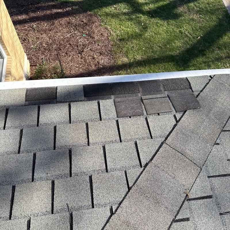Asphalt shingles with hail damage near roof edge